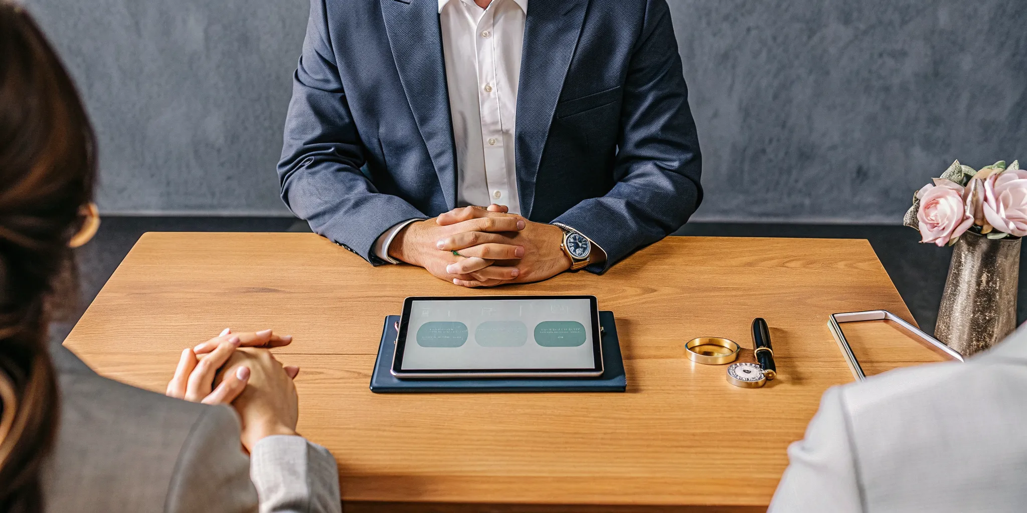 Minister for hire explaining wedding officiant rates to a couple.