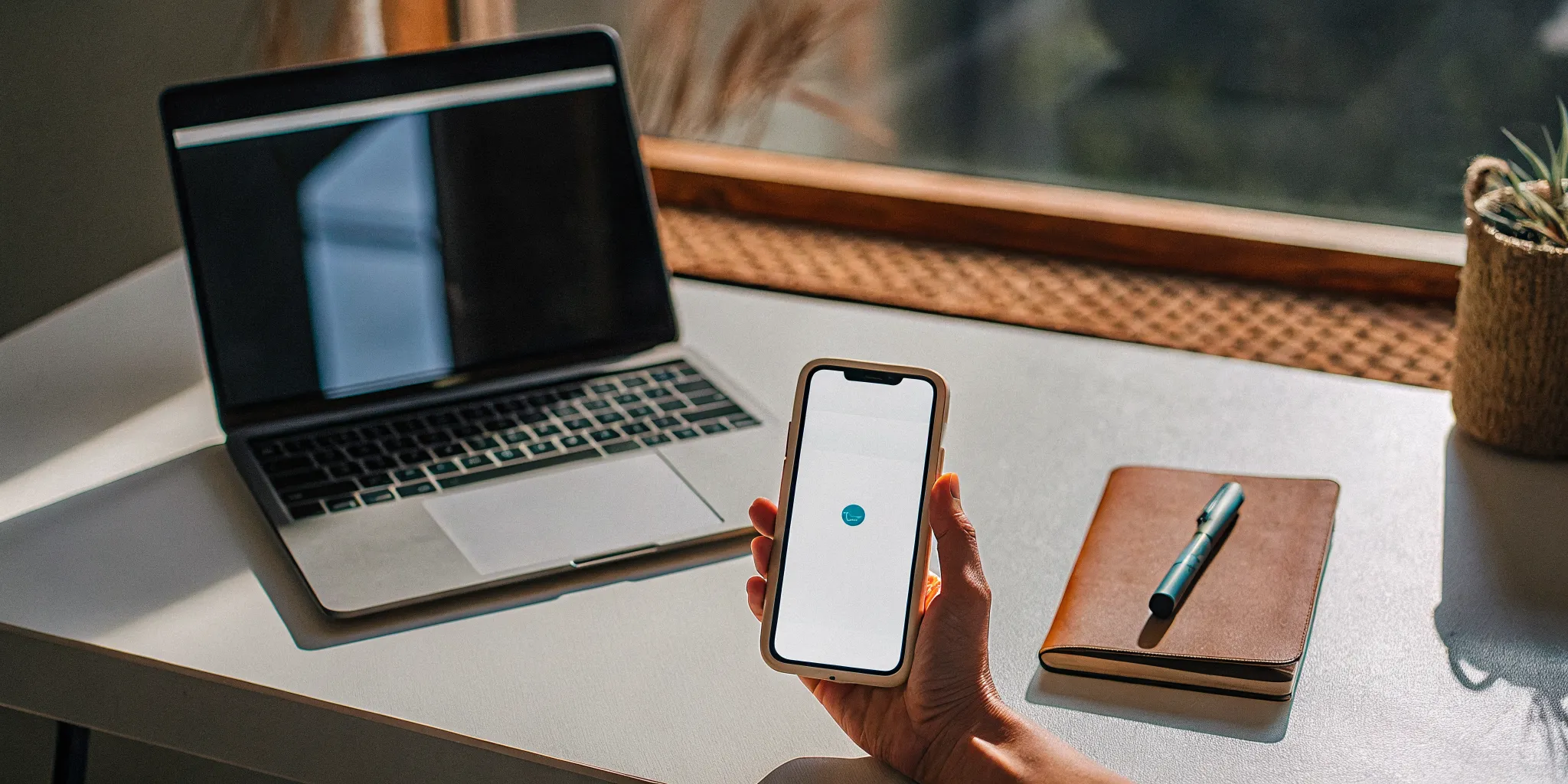 Person at a desk searching on their phone for how to get ordained fast online.