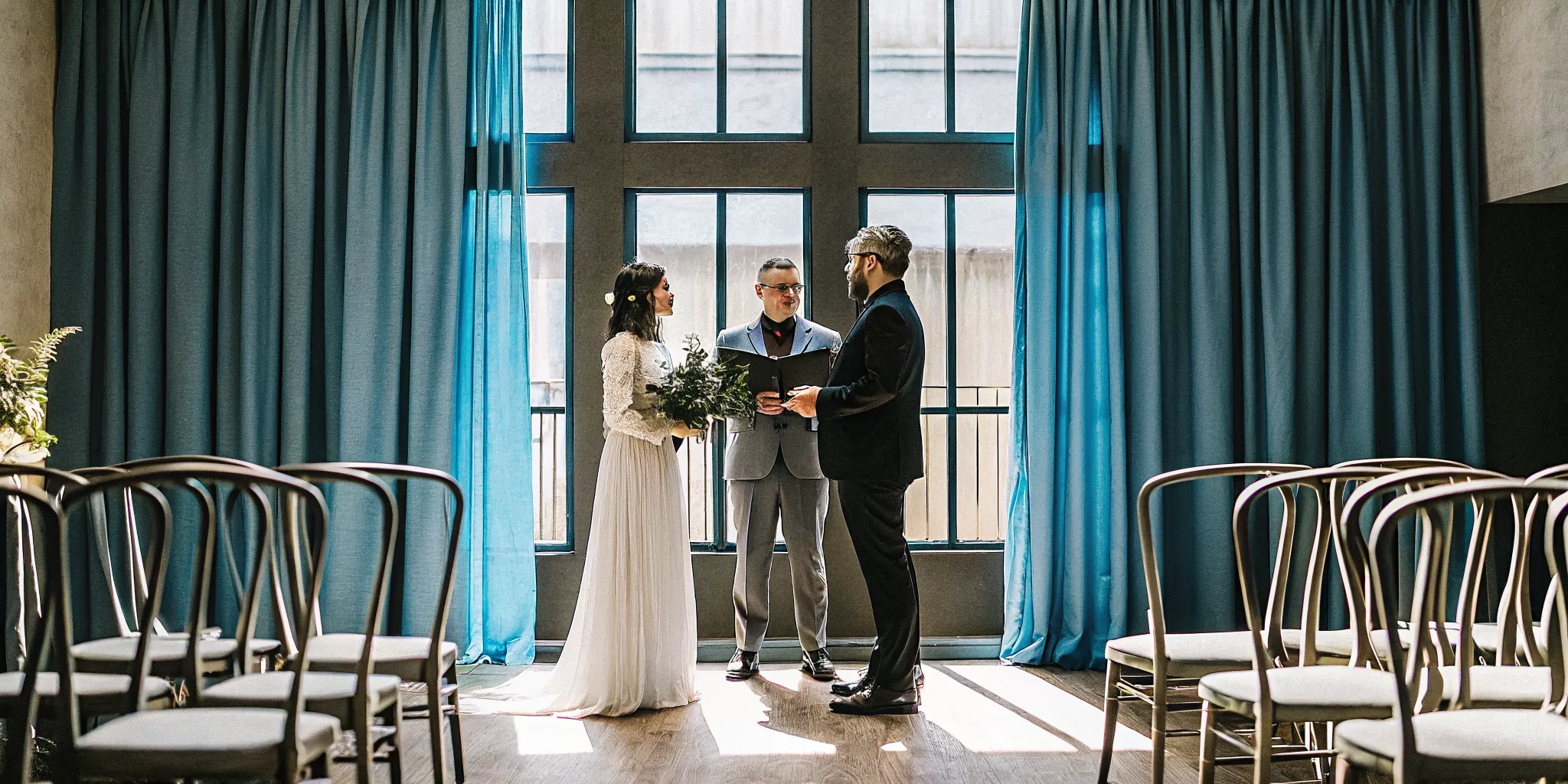 A minister speaking to a bride and groom during their wedding ceremony.