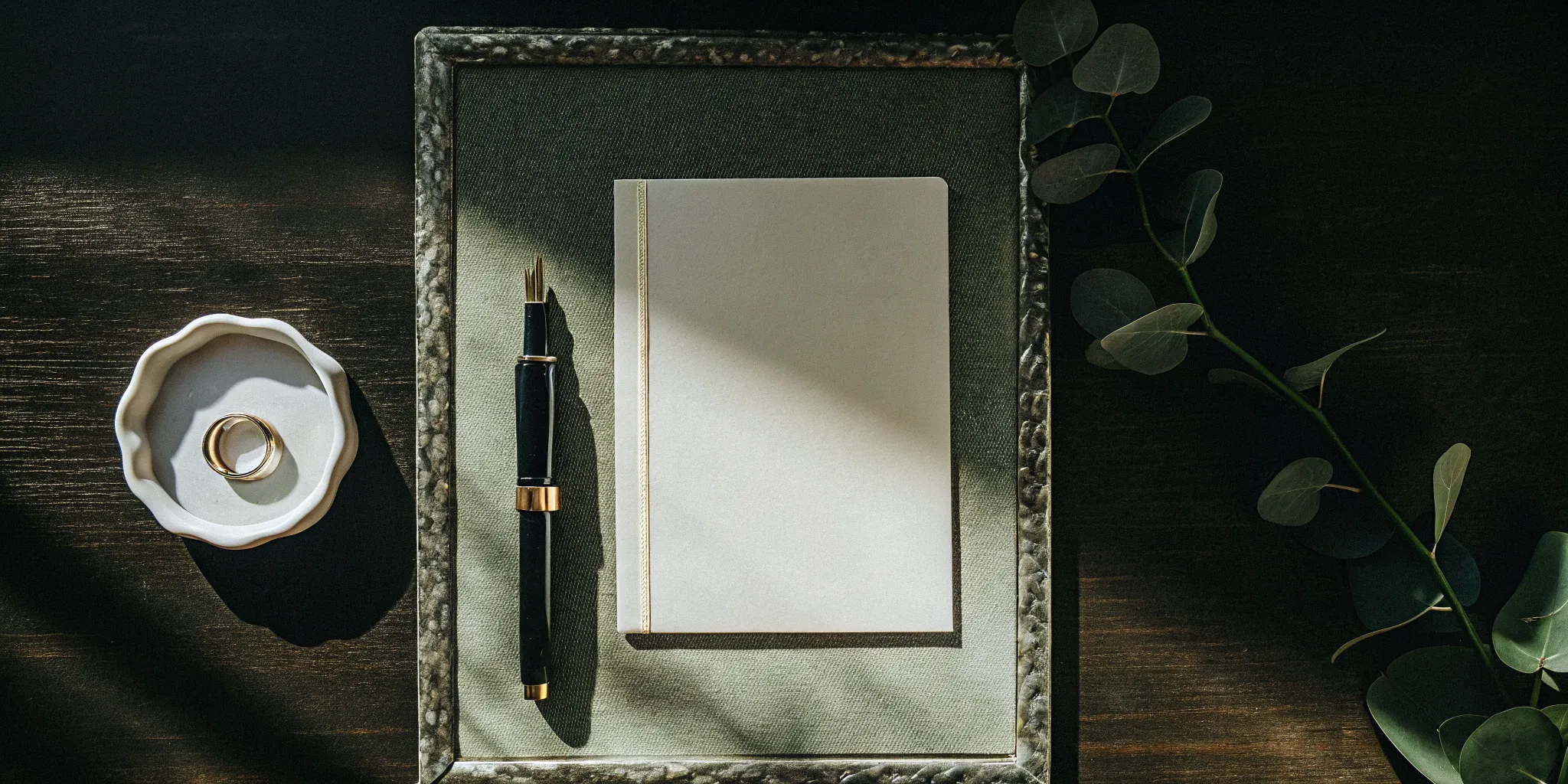 Wedding officiant's ordination certificate with a pen and wedding rings.