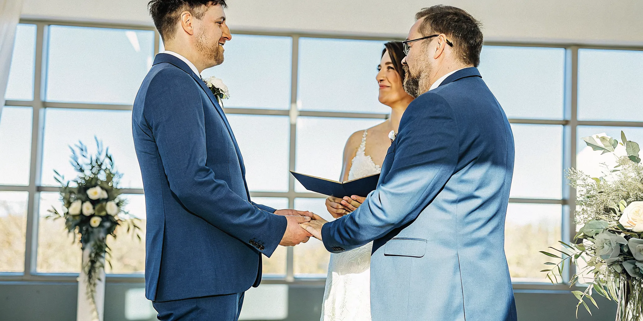 A first-time wedding officiant leads two grooms through their vows during the ceremony.
