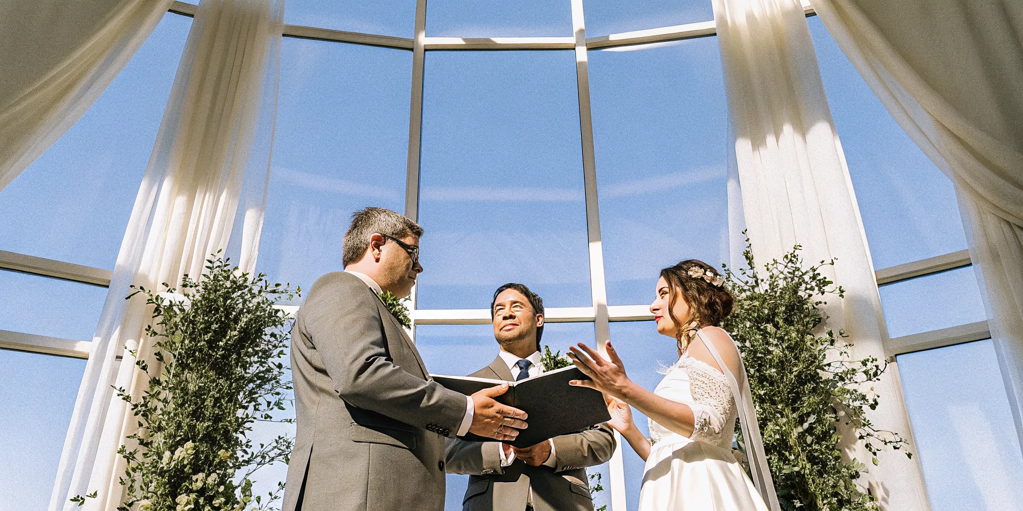 Wedding officiant performing a personalized ceremony they wrote for a couple.