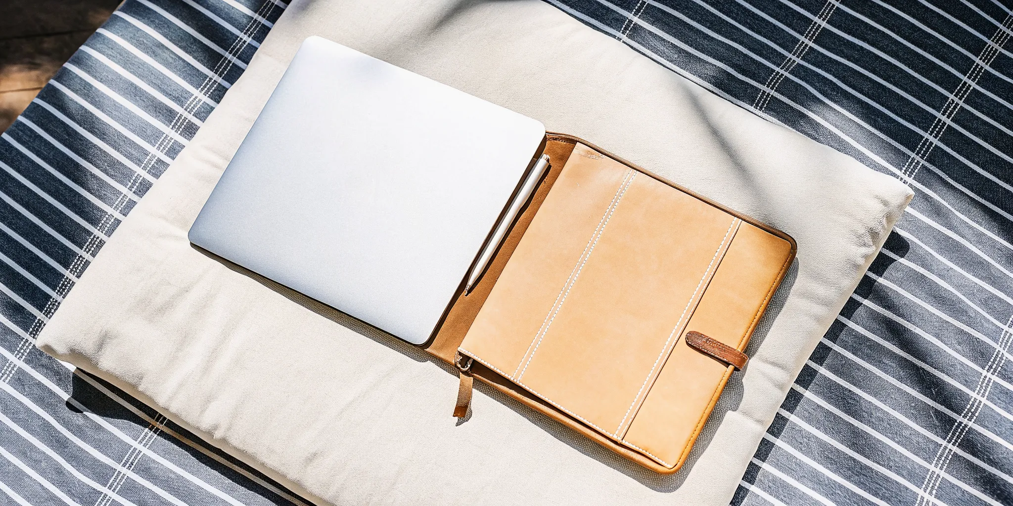 A laptop and planner for starting a wedding officiant business.