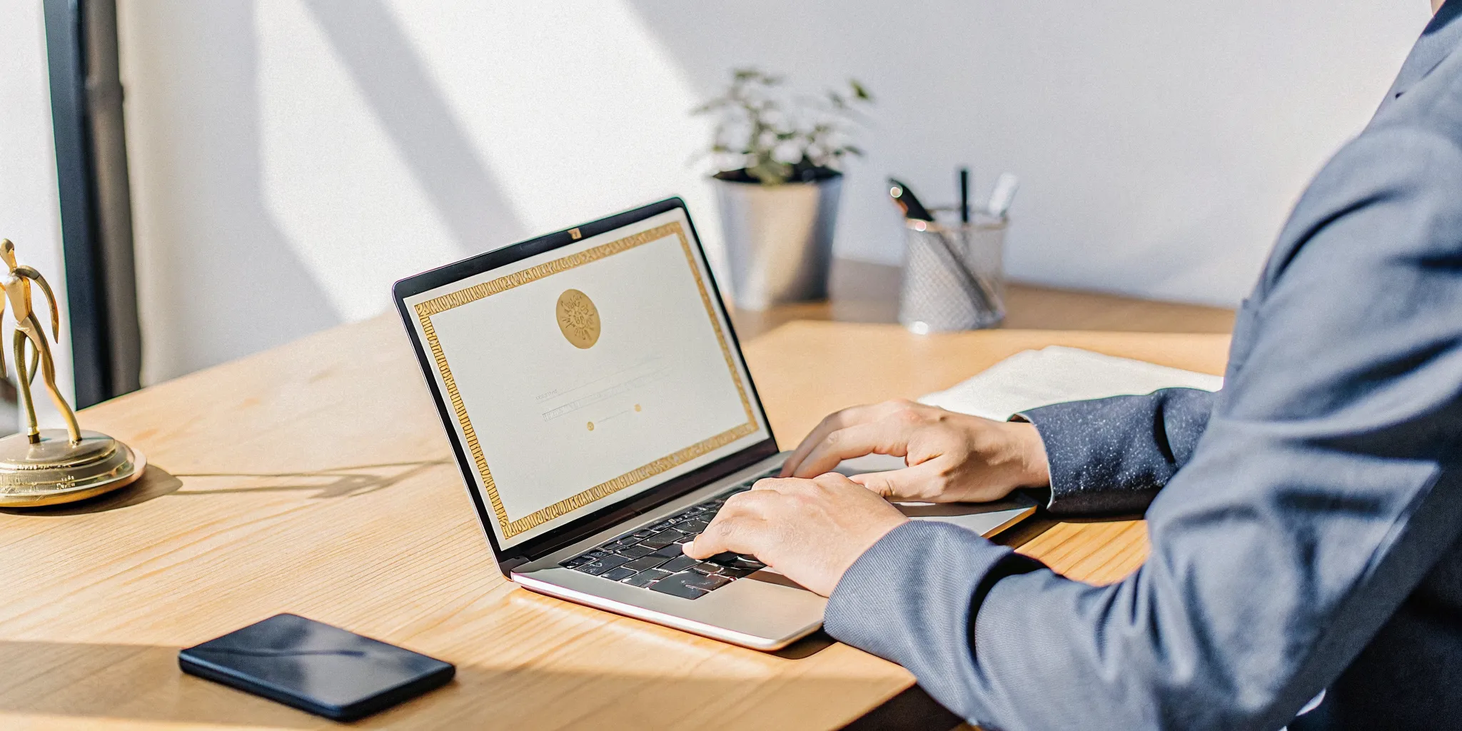Man in a suit uses a laptop to become an ordained minister online for free.