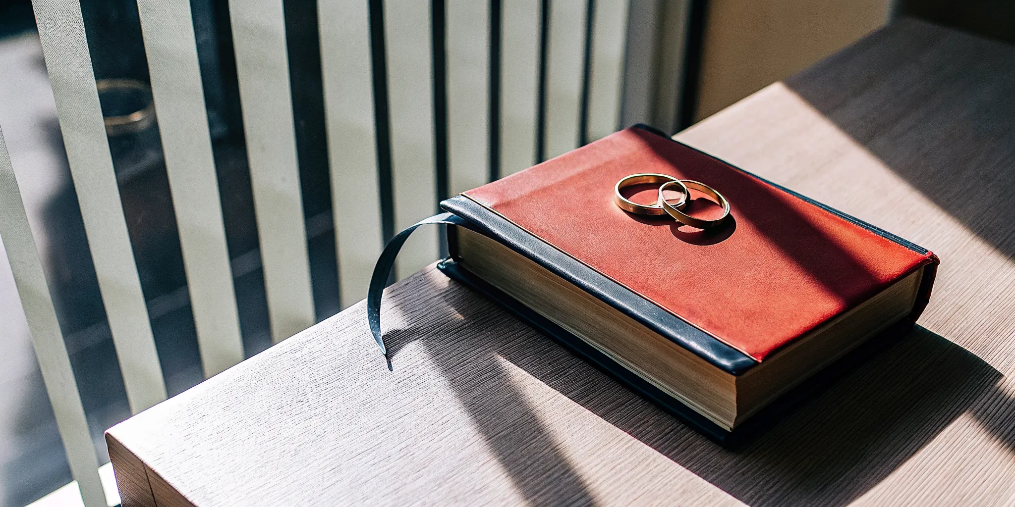 Two gold wedding rings on a Bible, the foundation of a God-ordained marriage.