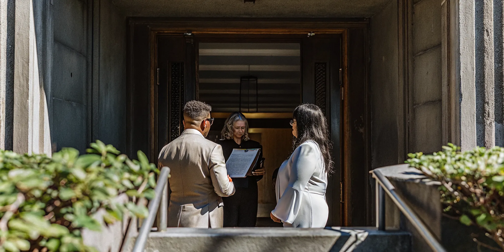 A professional wedding officiant holding a marriage certificate in Houston Texas