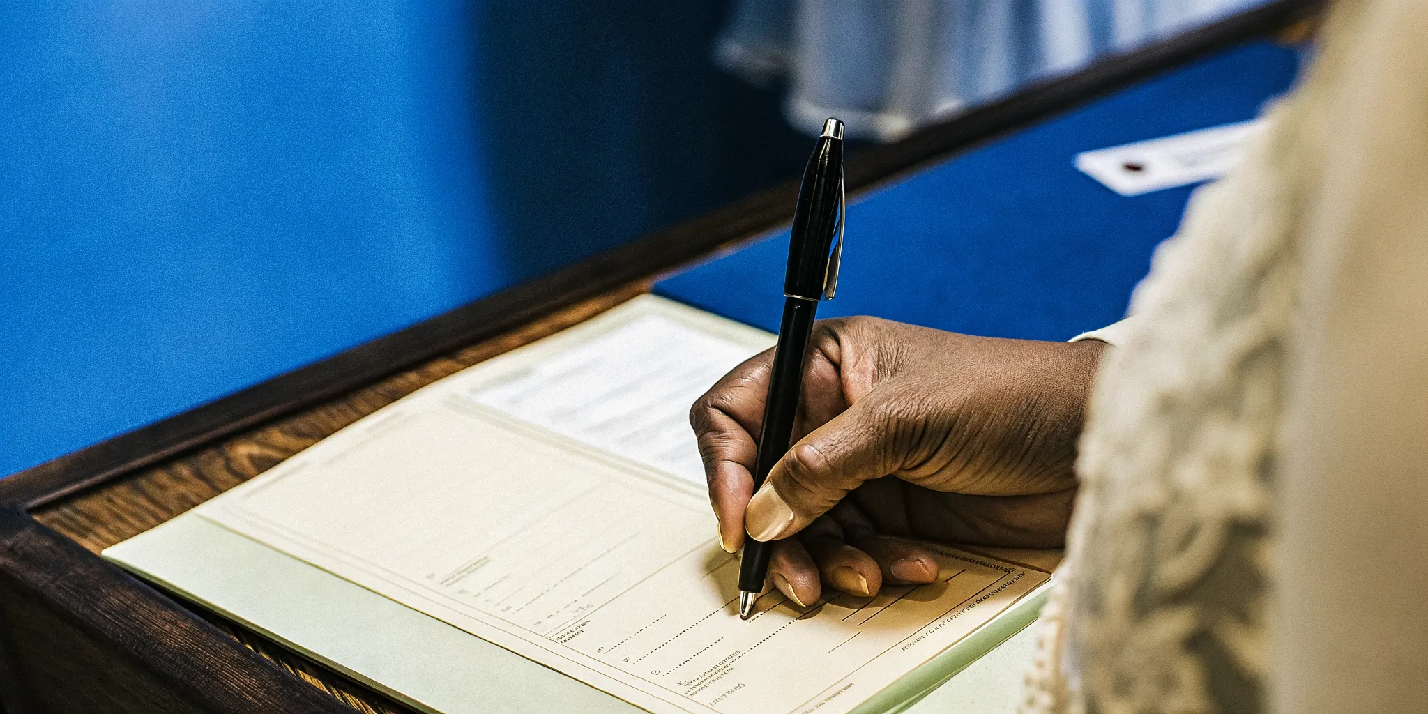 A minister reviewing legal paperwork and a marriage license at a desk