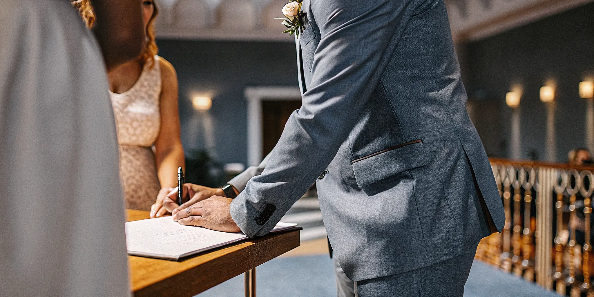 A professional wedding officiant performing a legal ceremony and signing a marriage license in Philadelphia.