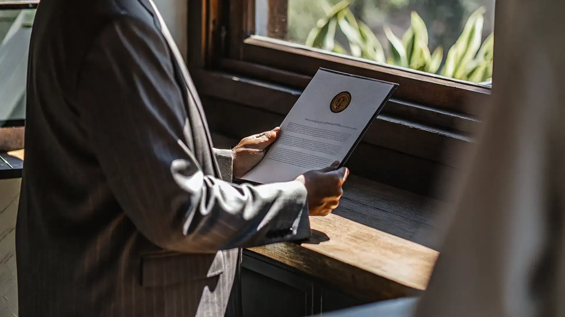 Newly ordained minister holding an ordination certificate document in a professional setting
