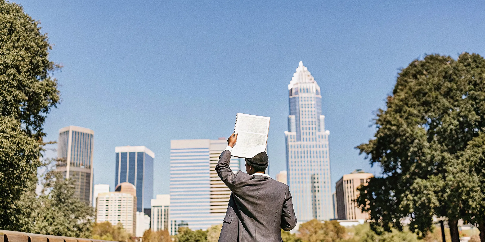 Ordained minister credentials in front of Charlotte skyline on a sunny day