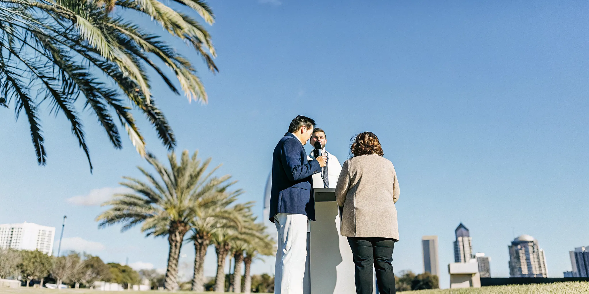 Newly ordained minister speaking with a couple in a sunny Tampa park