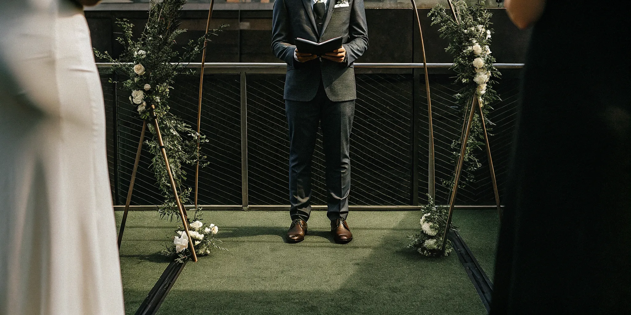 Paid wedding officiant leading an outdoor wedding ceremony.