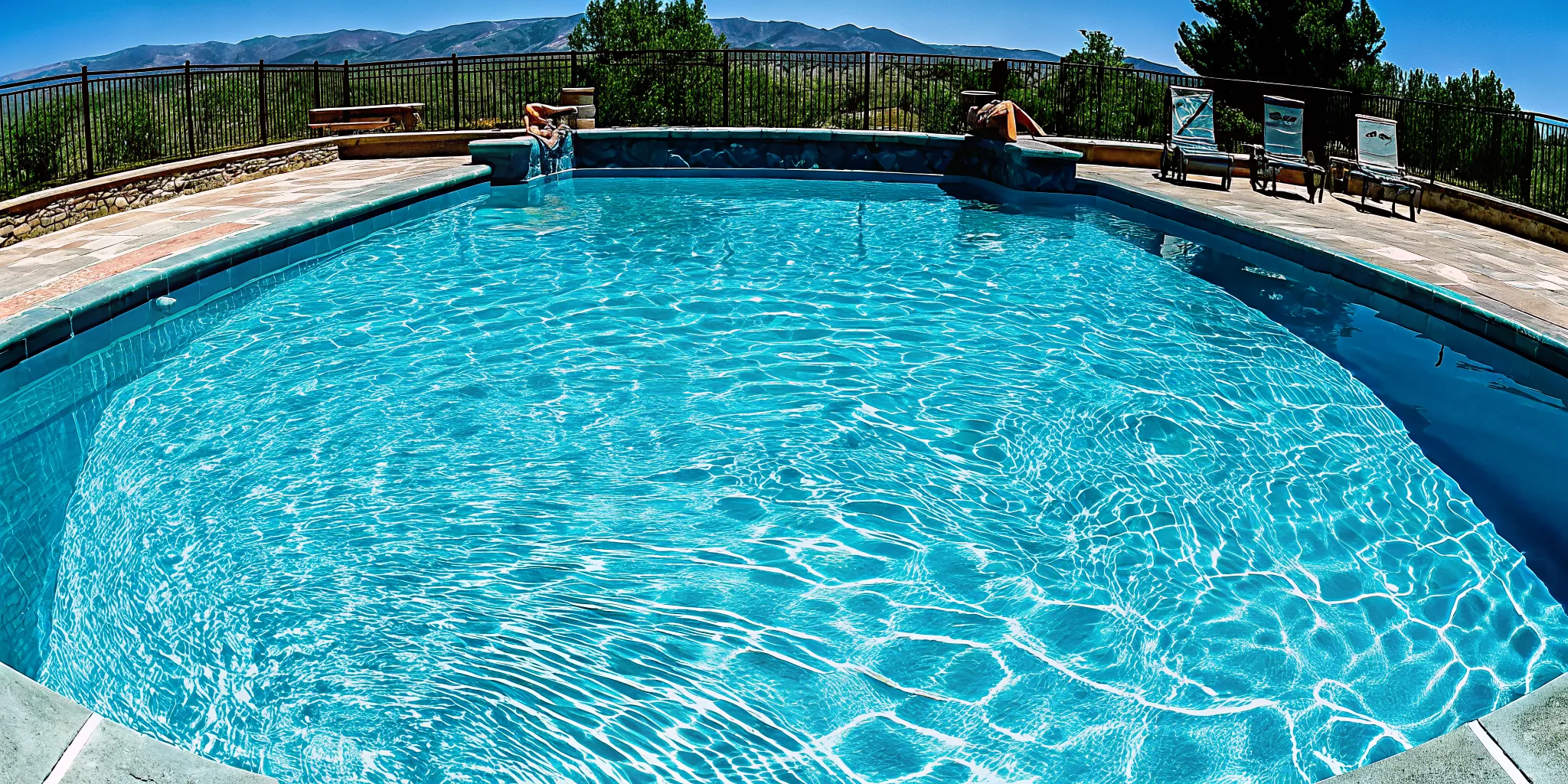 A newly replastered swimming pool with a smooth finish and sparkling blue water.
