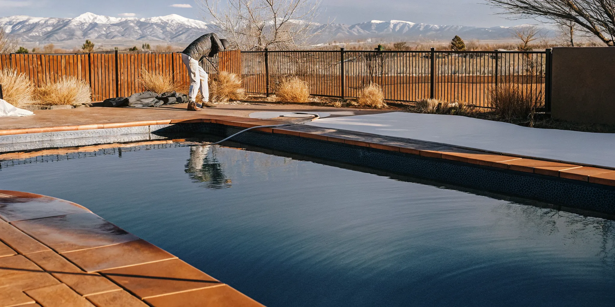 Technician opening a backyard pool in Colorado