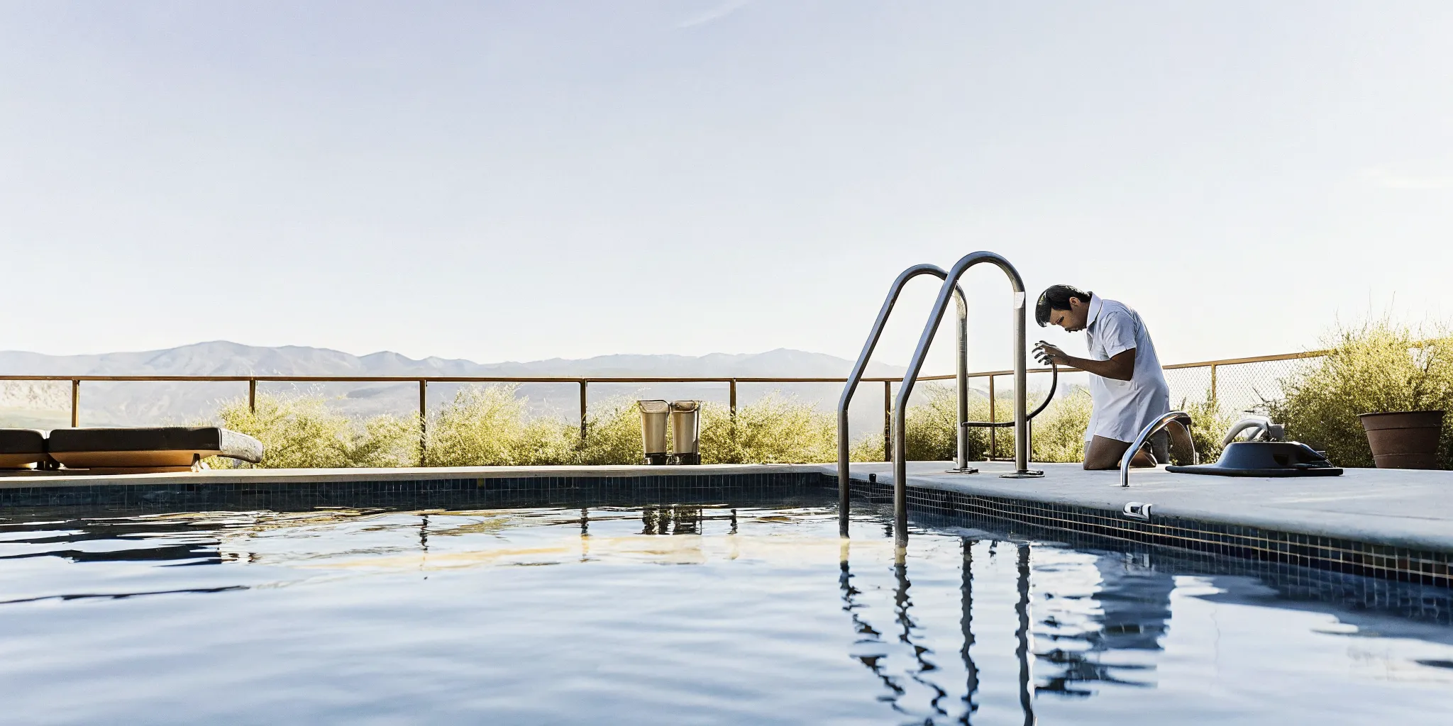 Pool technician testing chemical levels at a Denver commercial swimming pool