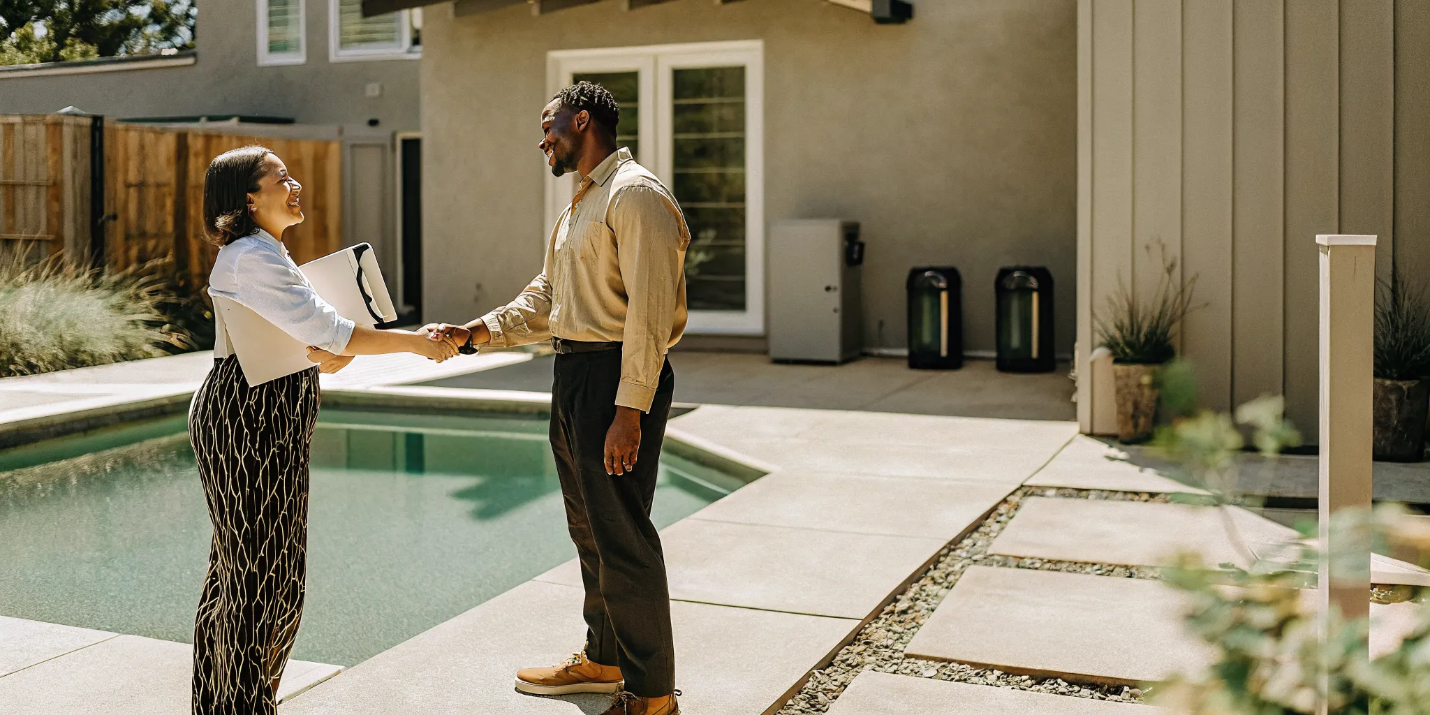 Pool technician and home buyer discussing equipment inspection at a residential Denver pool