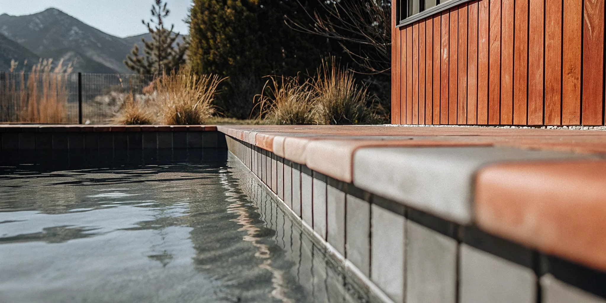 Smooth white plaster pool surface filling with clear water in a Denver backyard