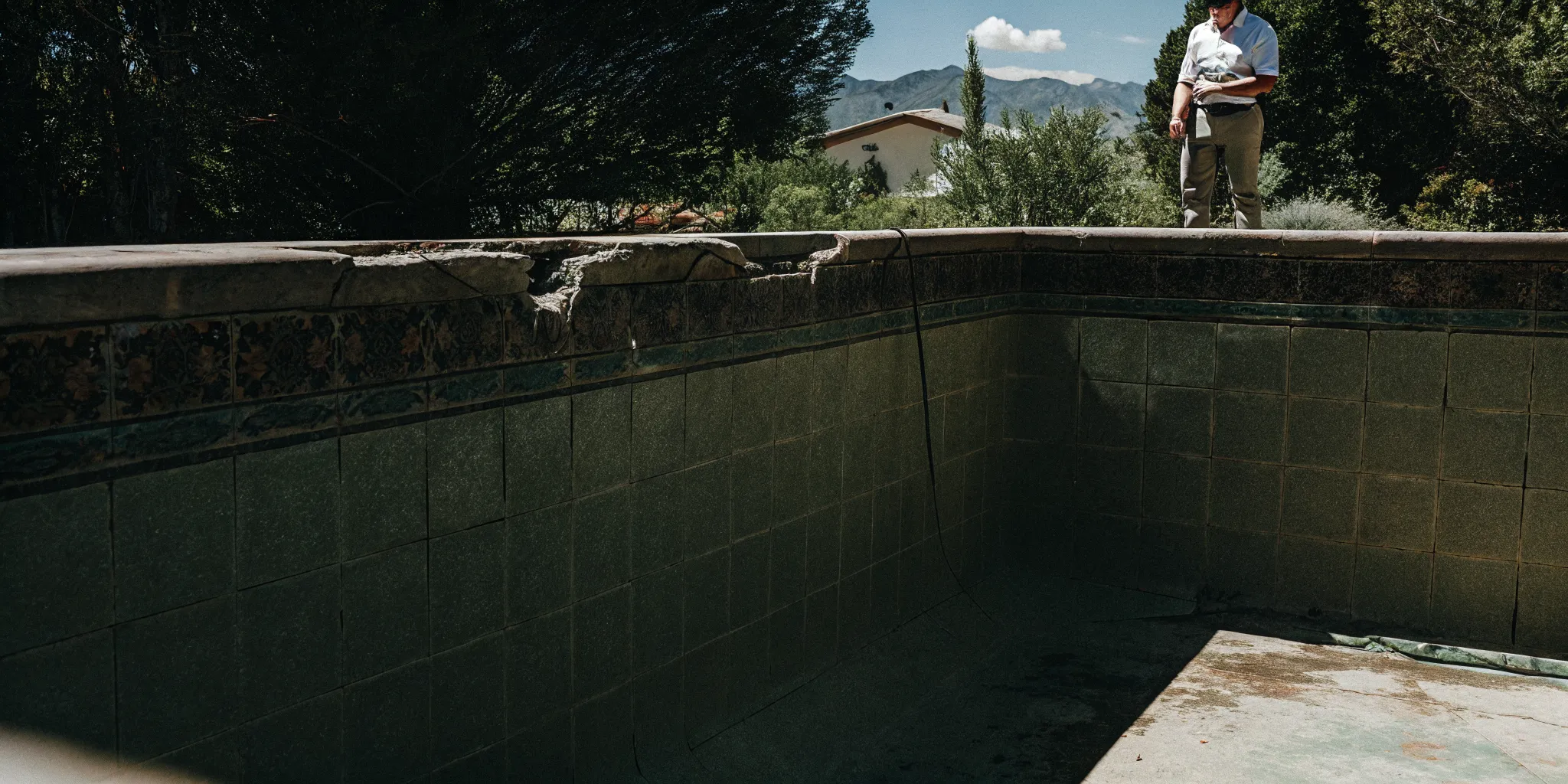 Colorado backyard pool showing cracked plaster and faded tile needing renovation