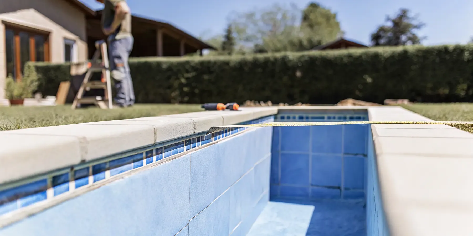Remodeled inground swimming pool with fresh tile and pebble interior in a Denver backyard