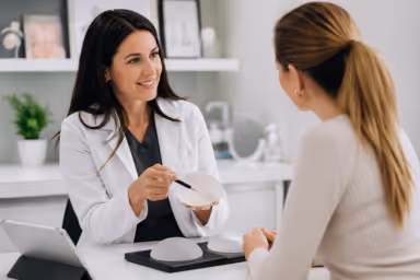 Plastic surgeon consulting with patient about cosmetic procedures in Greenwood Colorado