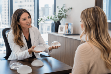 Woman reviewing breast augmentation options with a surgeon in Denver, Colorado for natural-looking results