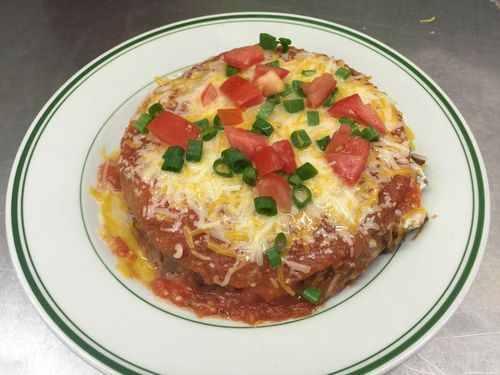A plate of food with tomatoes and cheese on it.