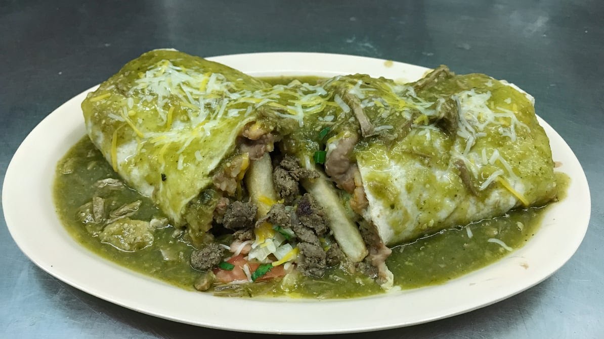 A plate of food with a green sauce on it.