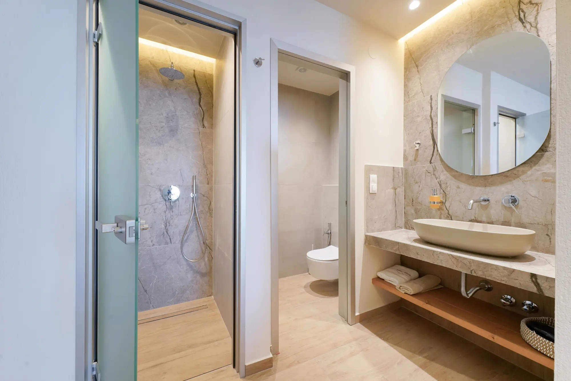 Marble bathroom with glass rain shower, vessel sink and separate WC room | Bathroom