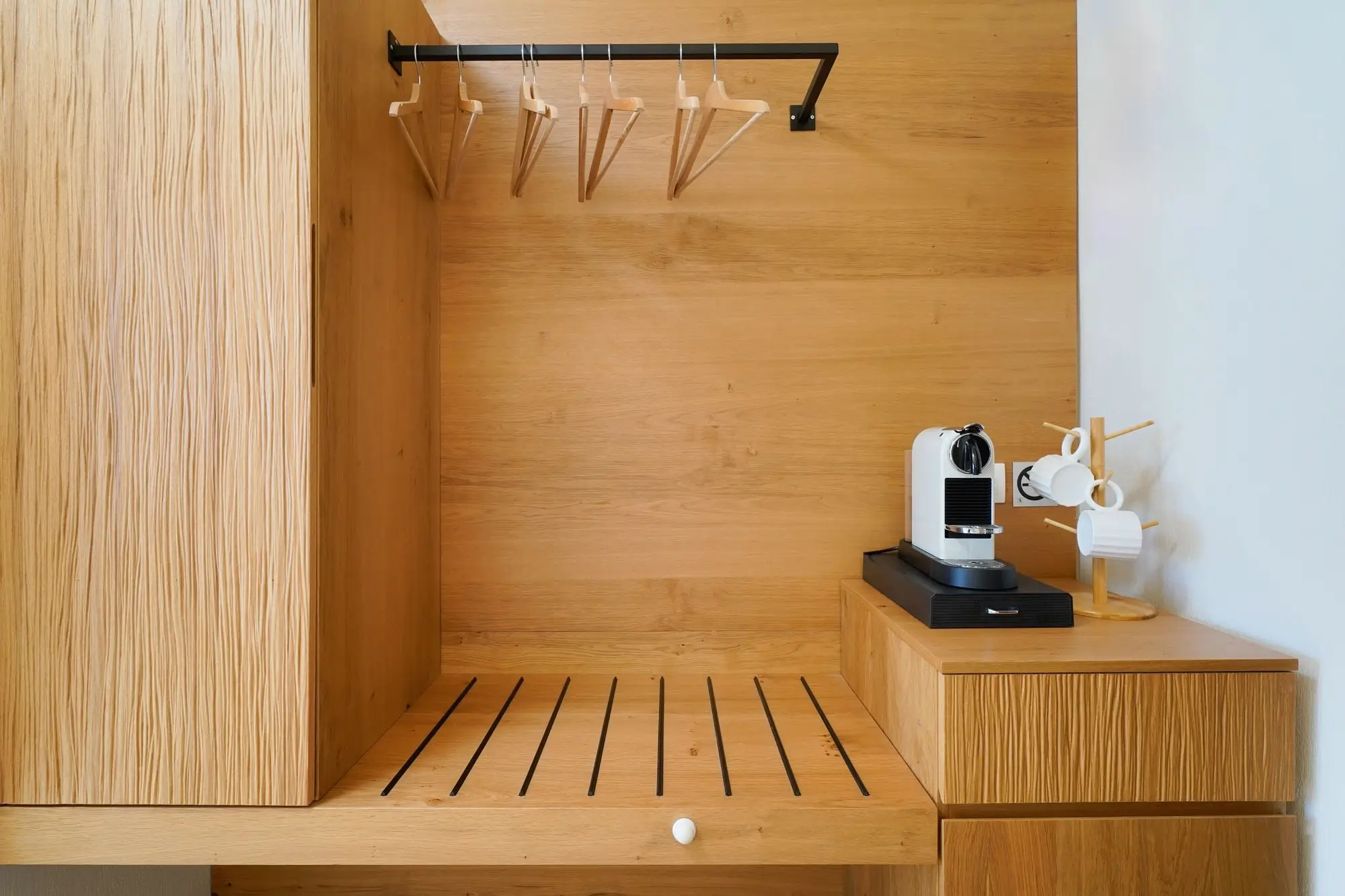 In-room wardrobe with wooden hangers and Nespresso coffee station | Suite Details
