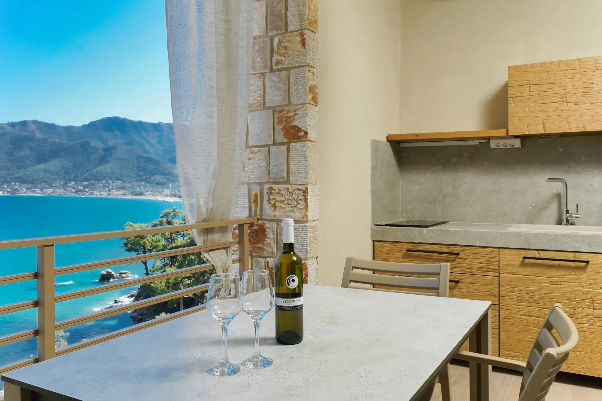 Outdoor kitchen dining table with sea and coastal view | Kitchen