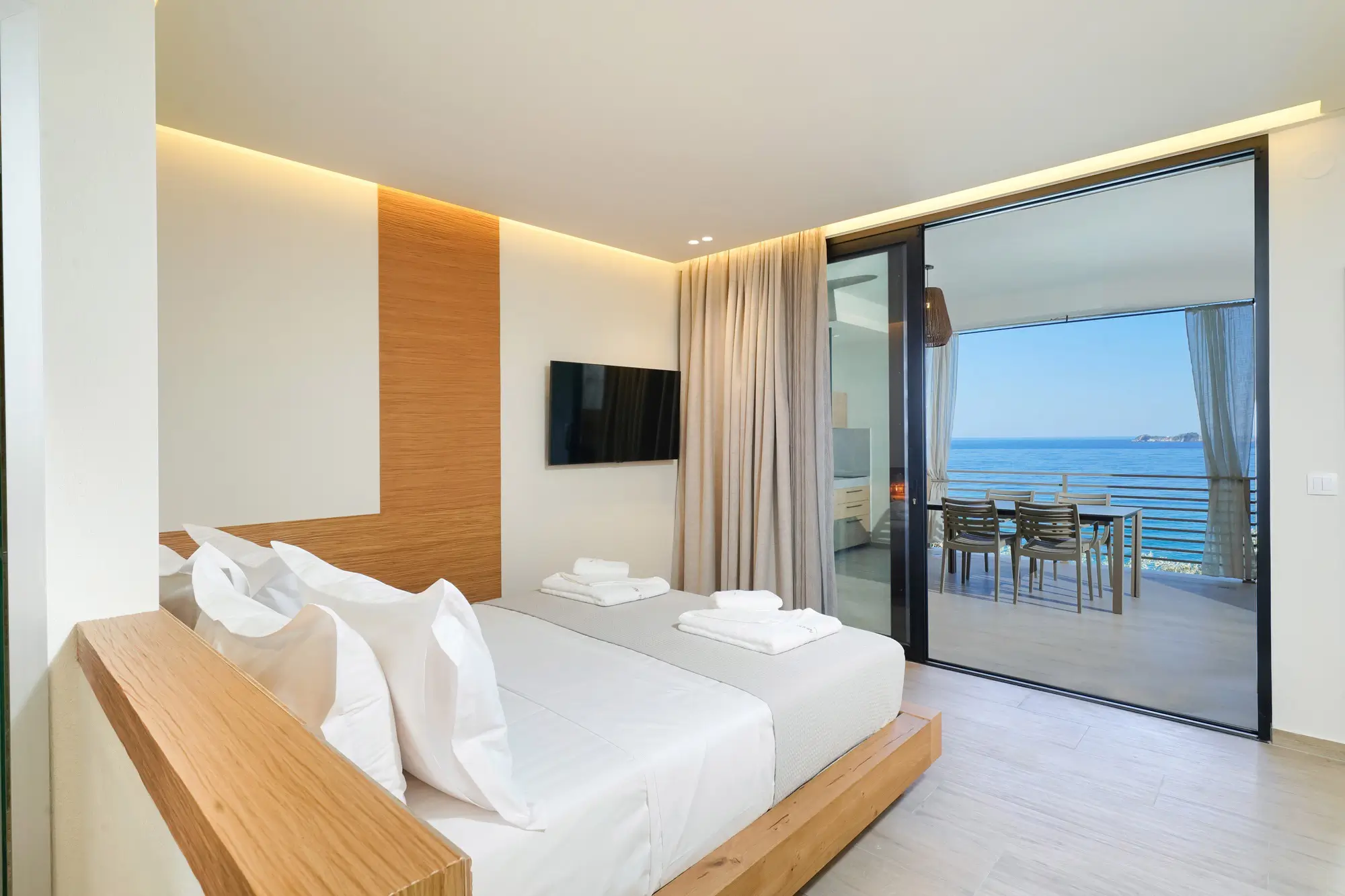 King bedroom with COCO-MAT bed, oak headboard and glass doors to sea-view terrace | Bedroom