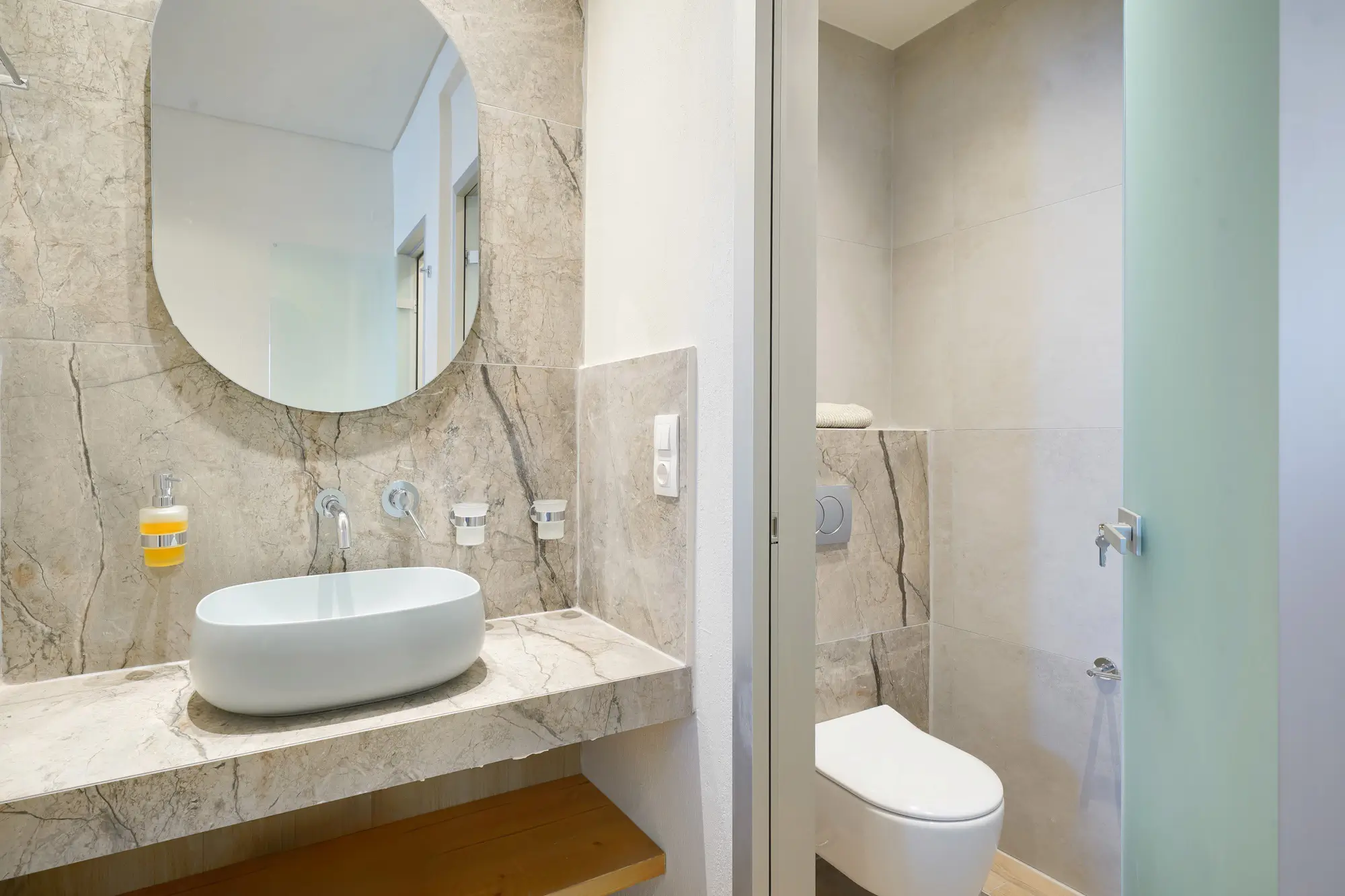 Second bathroom marble vanity with oval mirror and WC | Bathroom