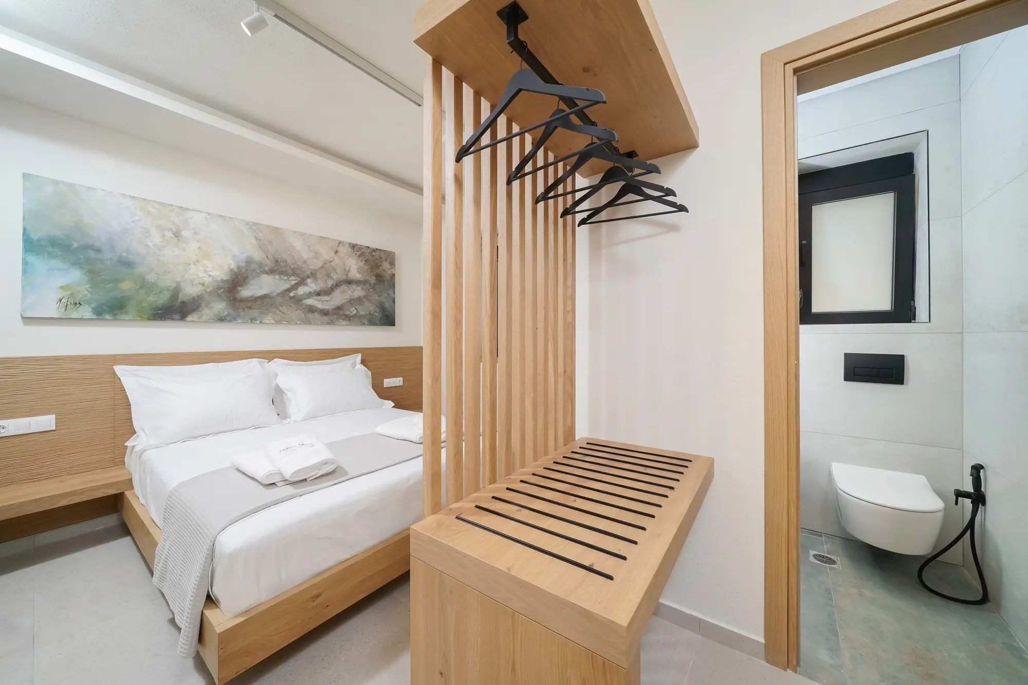 Bedroom two with COCO-MAT king bed, wardrobe and hillside garden view | Bedroom