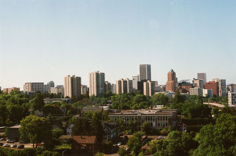 Scenic view of Portland, Oregon skyline with lush greenery in summer.