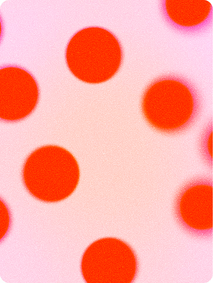 Pattern of large bright red circles with soft edges on a pink background with a grainy texture.