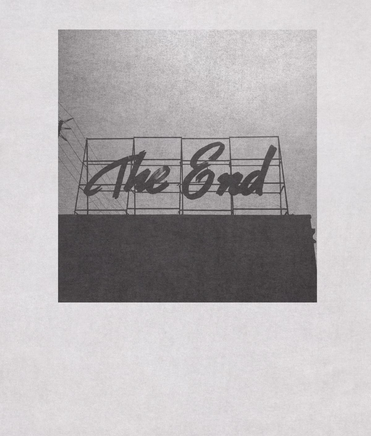 Black-and-white photograph of a sign reading The End