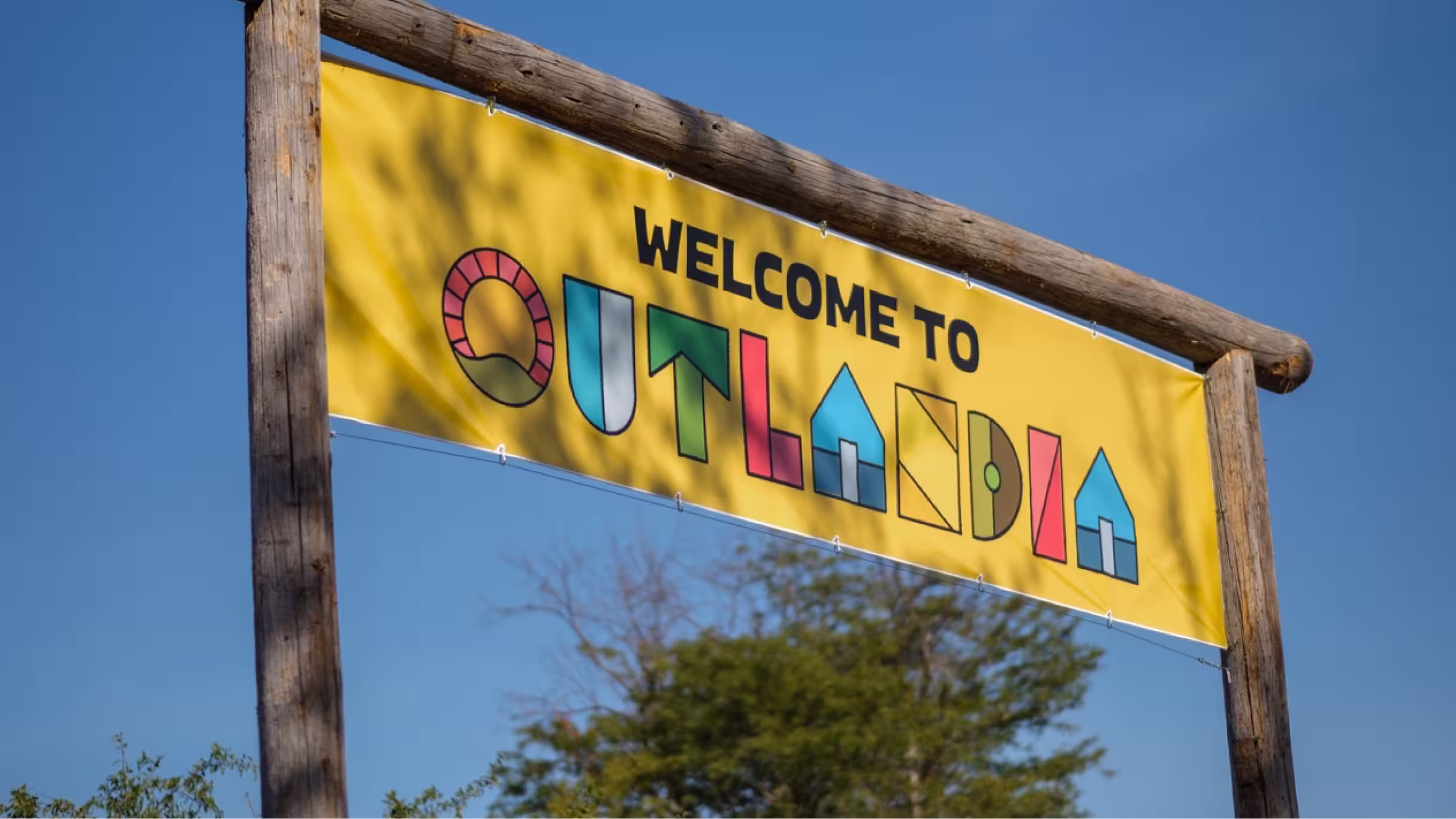 Yellow Welcome to Outlandia festival banner