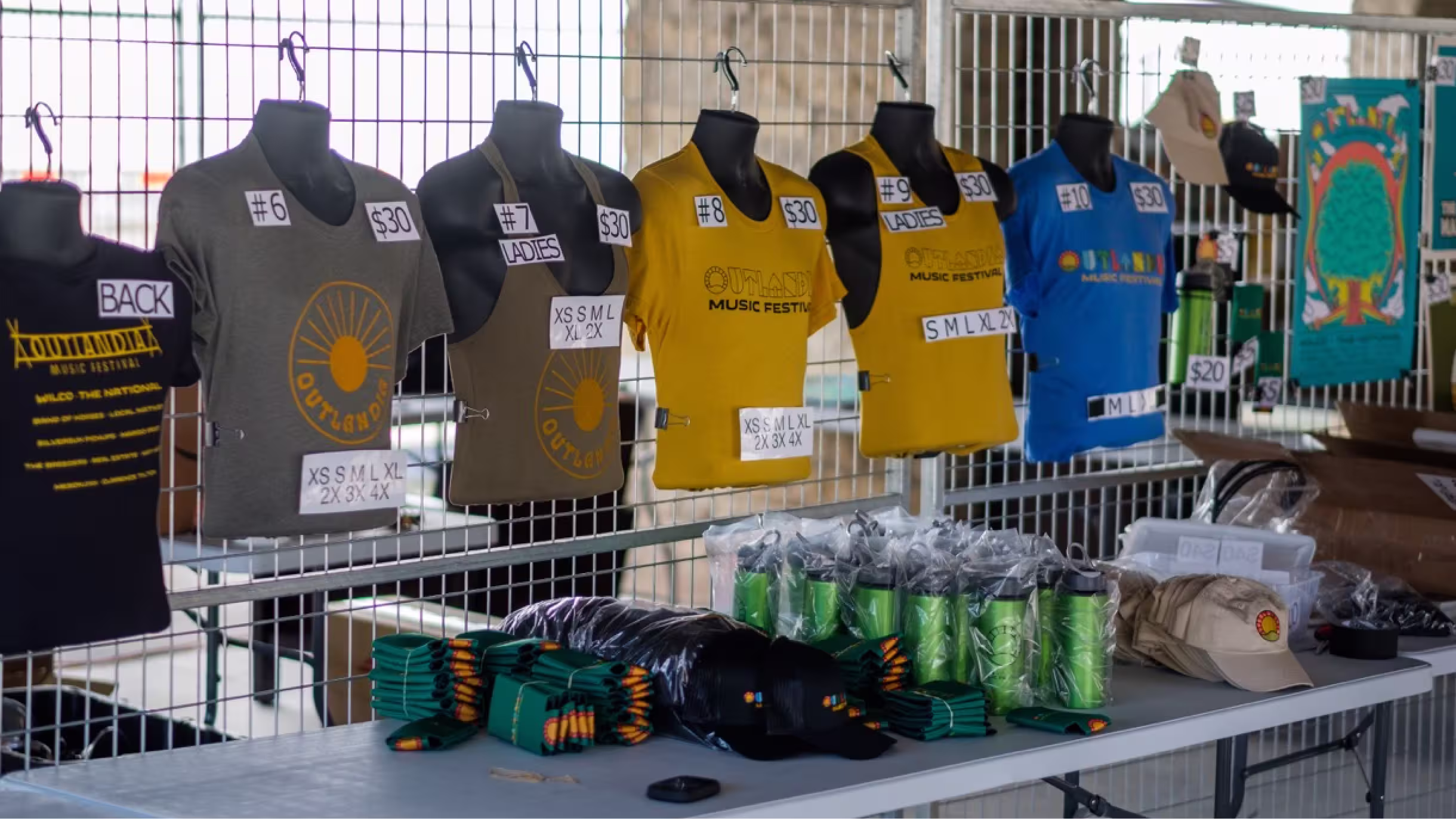 Outlandia merchandise table with branded shirts and goods