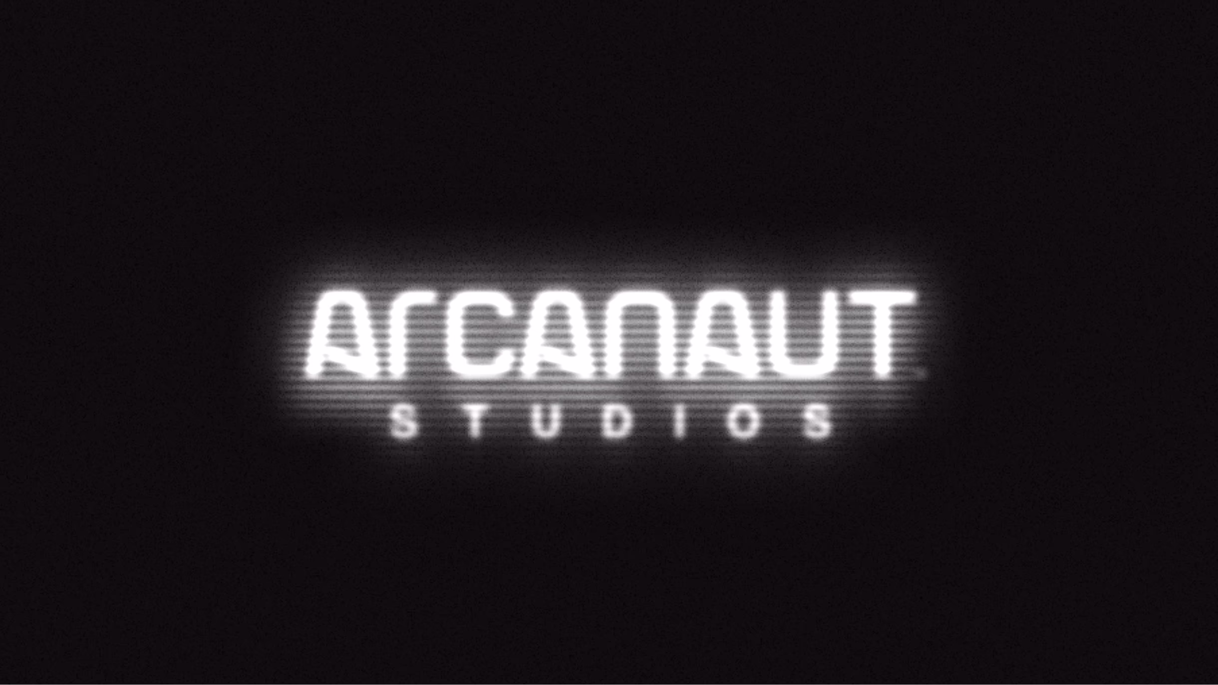Glowing white Arcanaut Studios wordmark on black