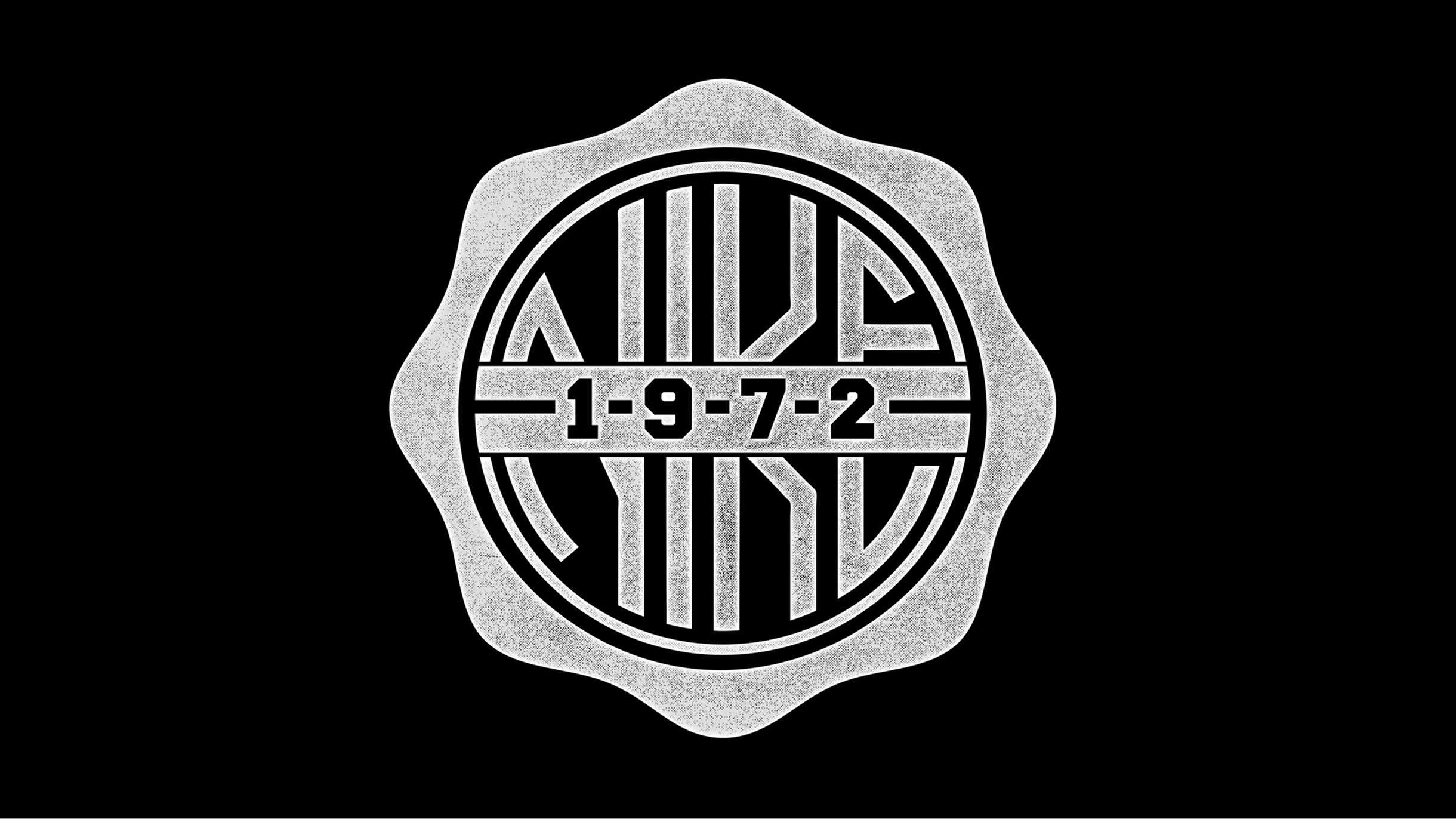 Circular black-and-white Nike 1972 badge