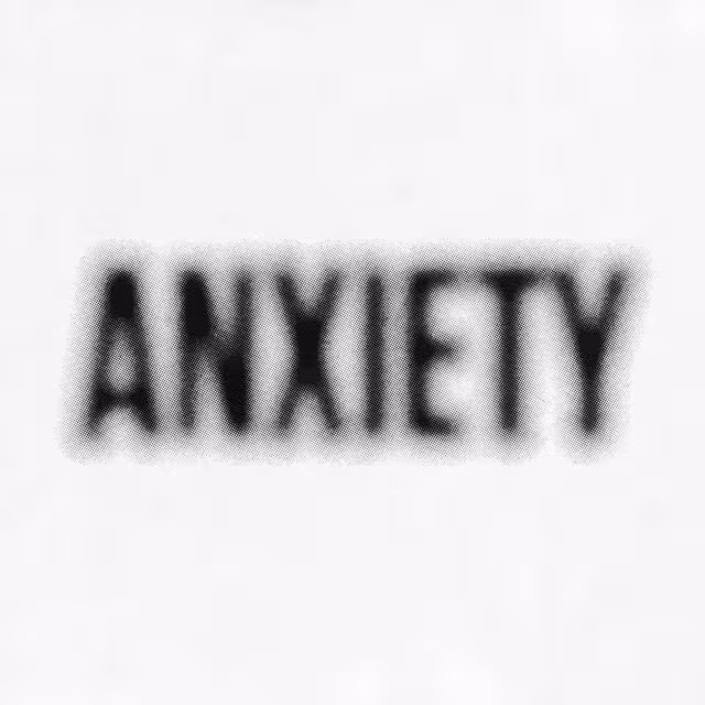 The word “ANXIETY” blurred in black on white