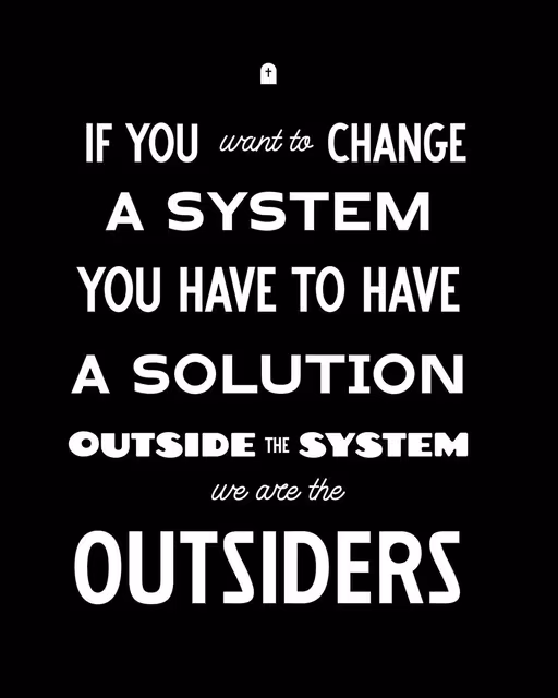 Black poster reading “If you want to change a system, you have to have a solution outside the system. We are the outsiders.”