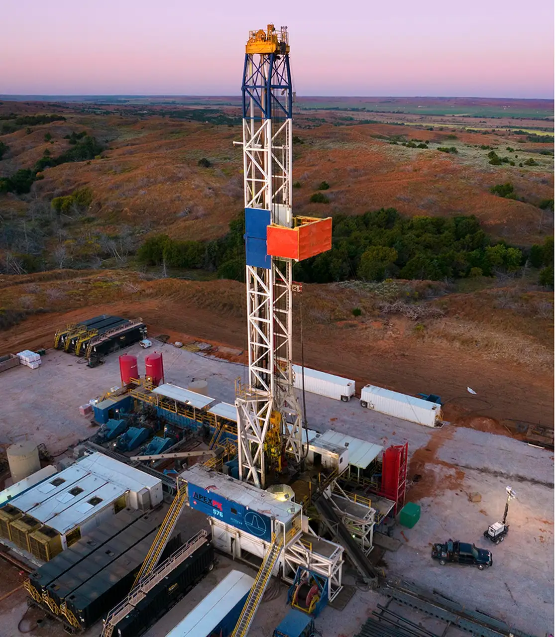 Wireless tower against an orange and blue sky