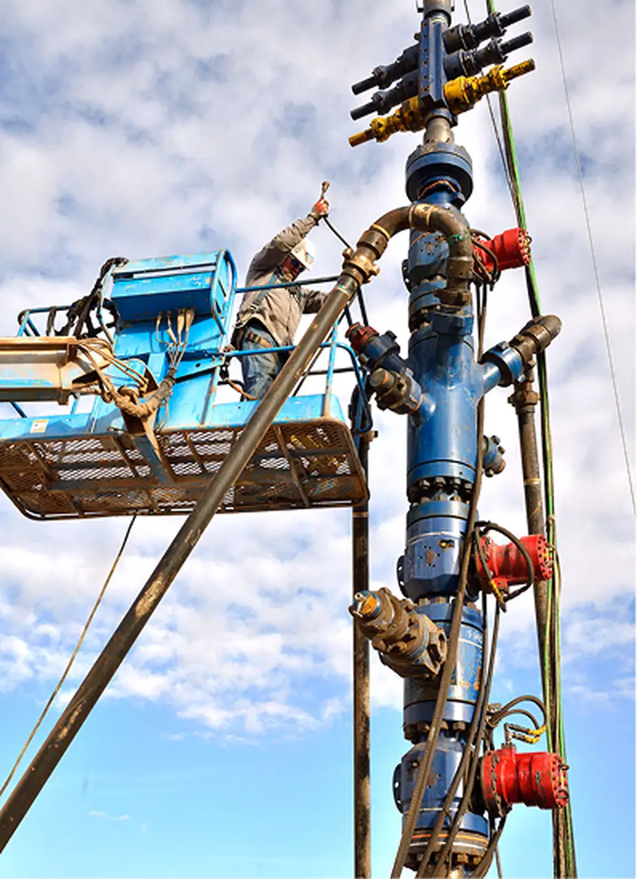 Oil and gas worker looking upward on a job site