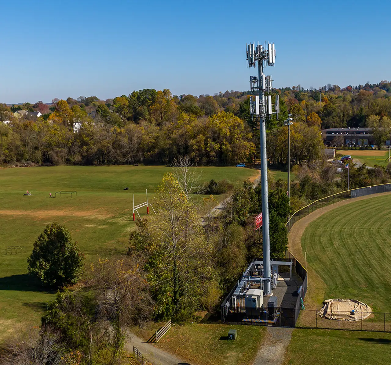 Wireless tower standing in an open field, square view