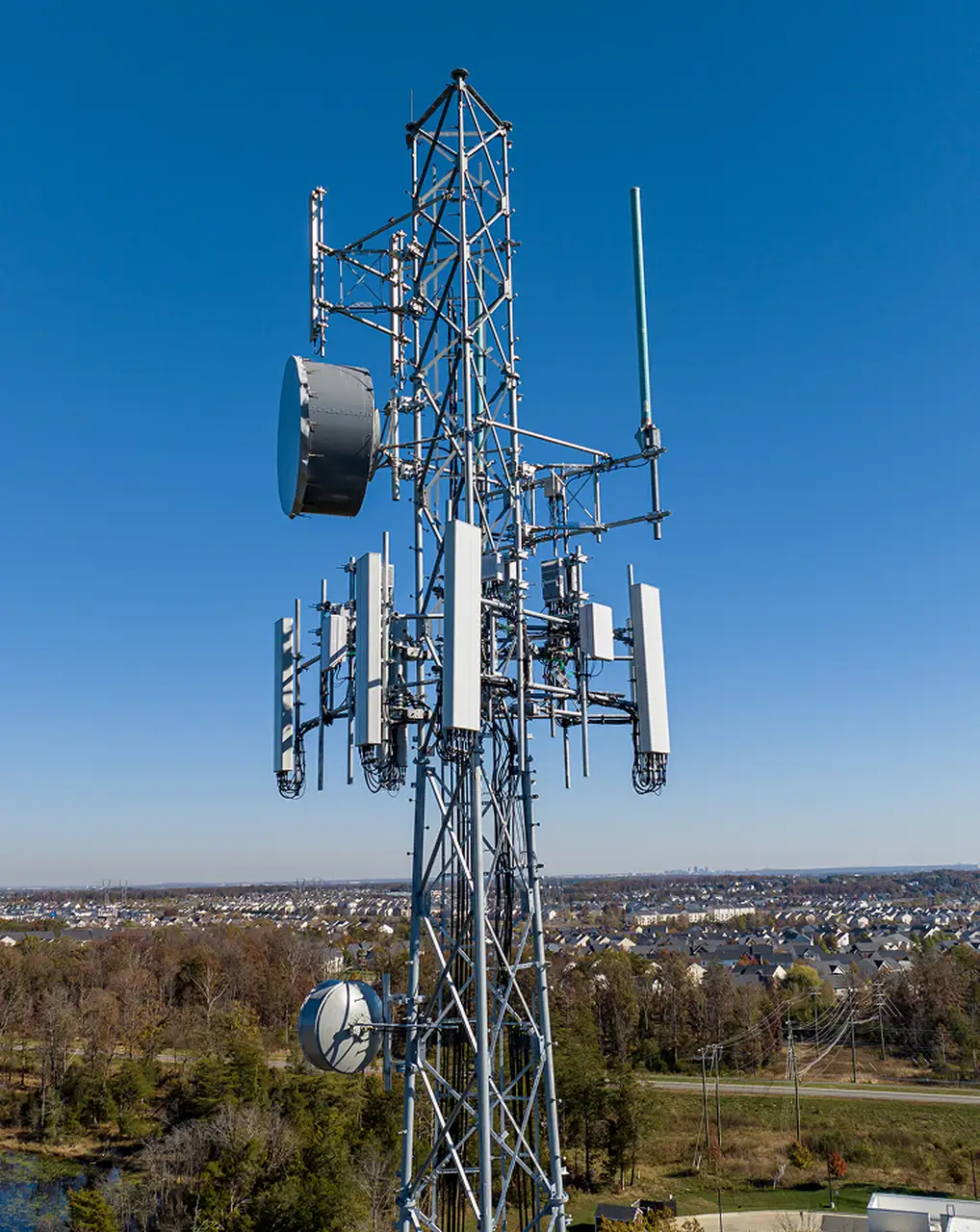 Wireless infrastructure tower in an open field
