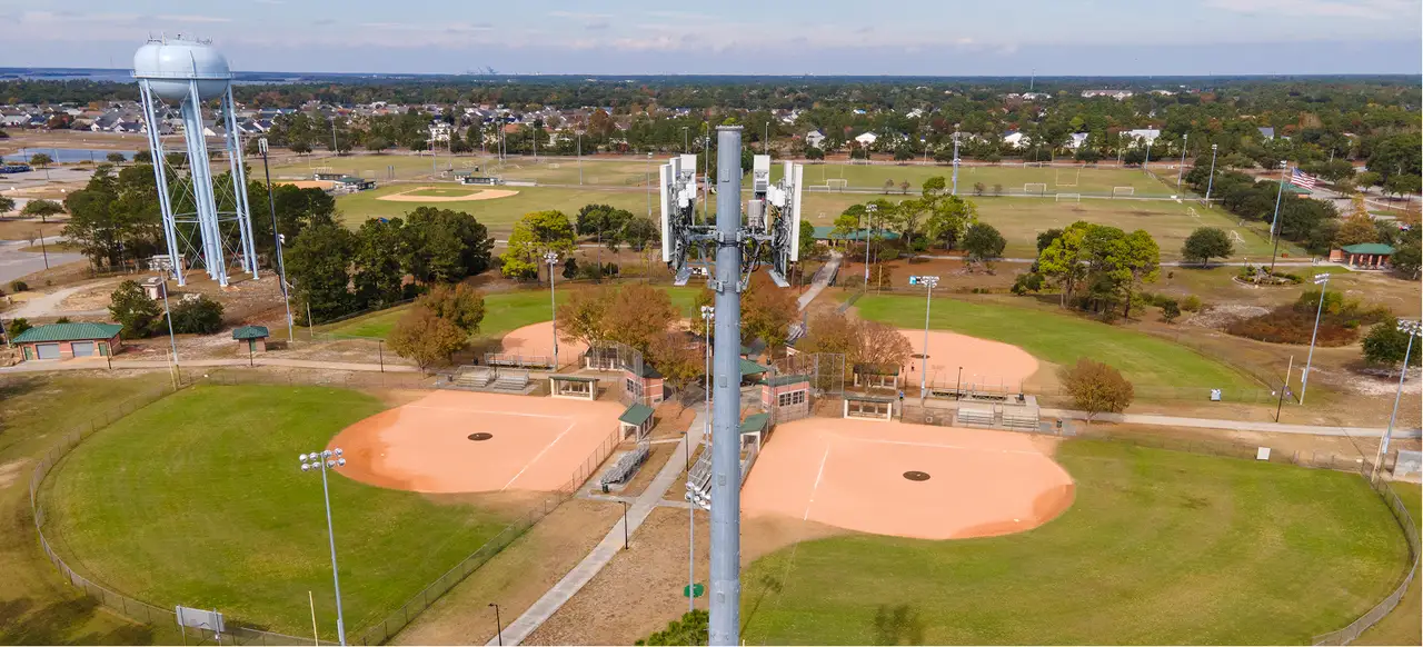 Wireless tower next to water tower and baseball fields