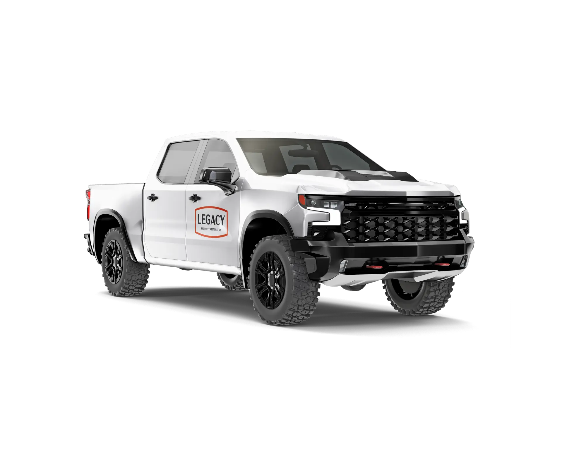 White pickup truck with large off-road tires and 'Legacy Property Restoration' logo on the front door.