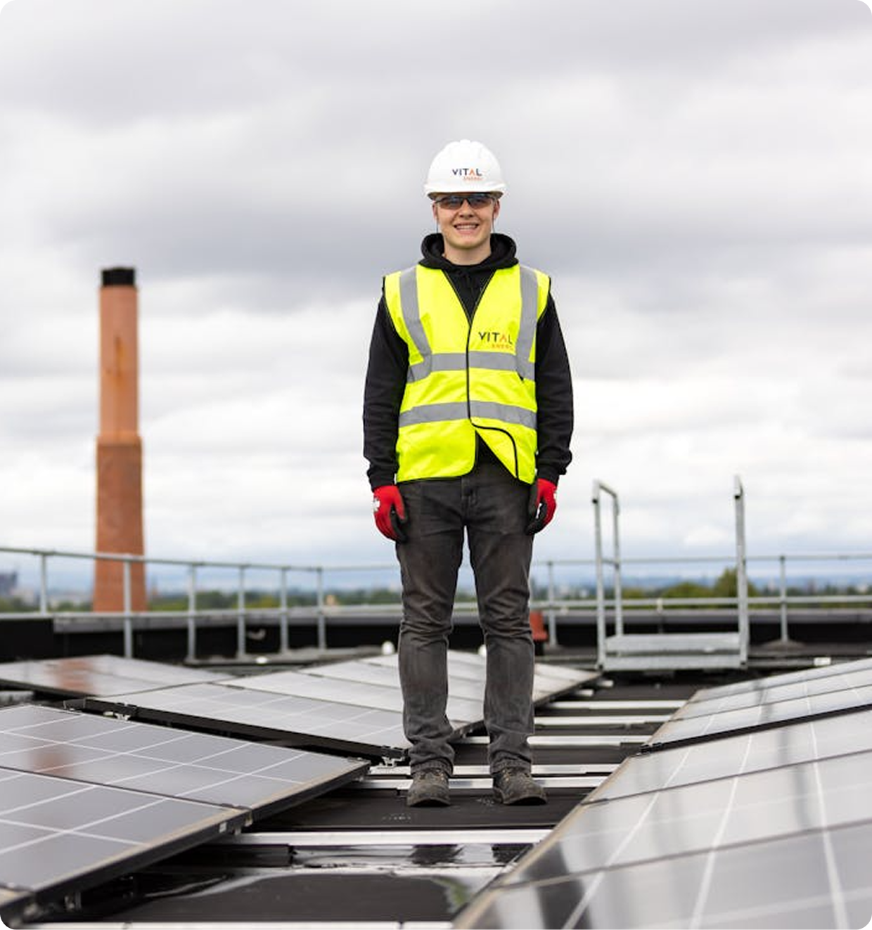 Single wind turbine with three blades against a clear blue sky.