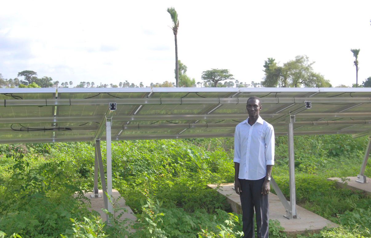 Single wind turbine with three blades against a clear blue sky.